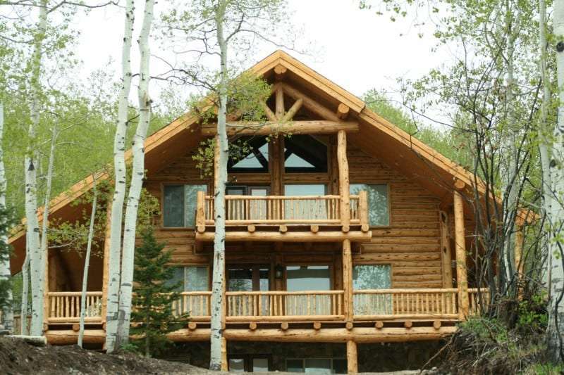 Totally Custom Build log Home with hand peeled Log Railing and Deck. Hand peeled Log Walls.
