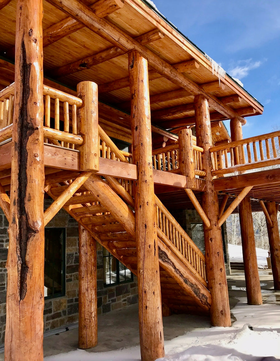 Custom Log stair case with log deck stained & Sealed handpeeled logs